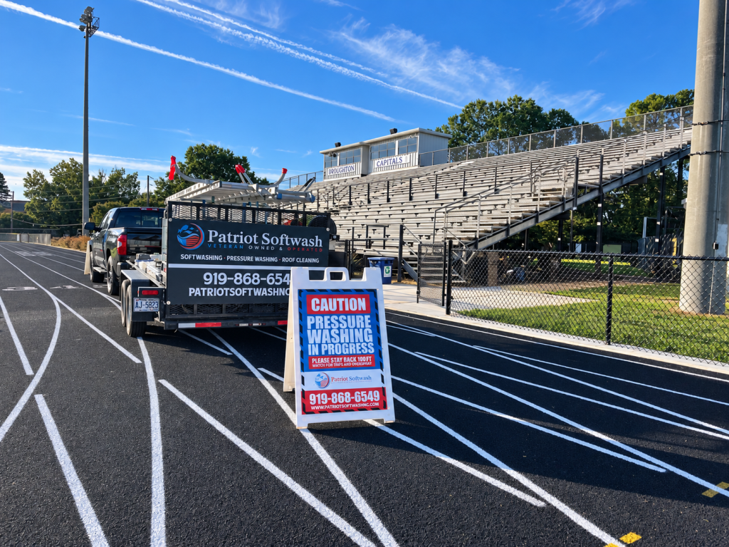Patriot Softwash truck and equipment at Broughton High School in Raleigh, NC, during a bleacher cleaning project.